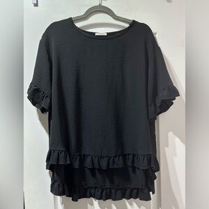 Black, flowy top with hi-low bottom.